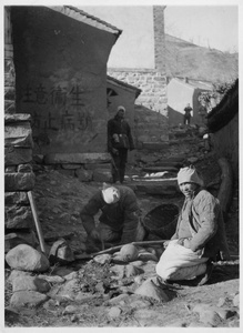 Militiamen planting a landmine in a village street on hearing news of a Japanese advance in their direction, Jinchaji