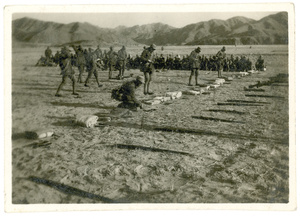 Bedding and weapons laid out in a row for inspection
