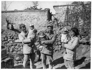 Three babies, including Erica Lindsay in the centre, with Dr Jiang Yizhen, 1943
