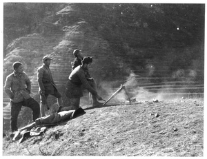 Soldiers and Dr Richard Frey (傅莱) testing a local copy of a small Japanese mortar, Jinchaji, 1943