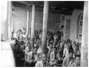 Chinese men and women at a meeting indoors, 1942
