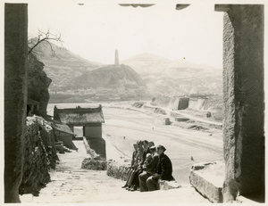 Members of the Dixie Mission resting on a wall, with the Baota Pagoda (宝塔山) in the background, Yan'an (延安)