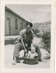 Hsiao Li Lindsay (李效黎) bathing baby Jim Lindsay, Yan'an (延安), 1945