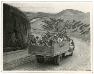 Men, women, and children in the back of a lorry between Suide (綏德) and Yan'an (延安), May 1944