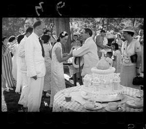 Hsiao Li Lindsay (李效黎) shaking hands with Dr Rudolf Loewenthal, the best man, next to the wedding cake, at the Lindsay's wedding party at Yenching University (燕京大學), Beijing (北京)