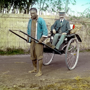 W.G.L. Riddle on a rickshaw, with driver, c.1913