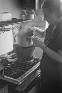 Marge Rosholt cooking on an improvised stove, Shanghai
