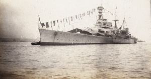 HMS Renown, dressed overall, at Hong Kong, during the Prince of Wales’ tour
